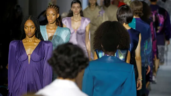 Models walk both toward the camera and away from the camera on a runway.