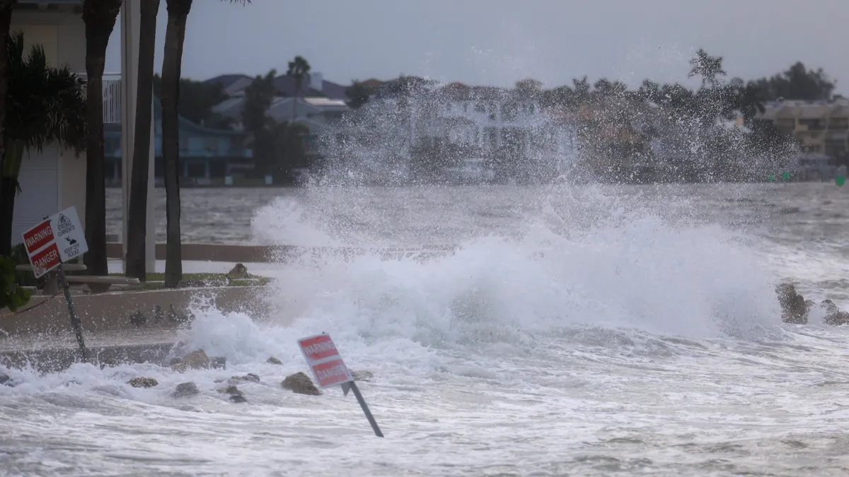 A wave violently crashes onto shore