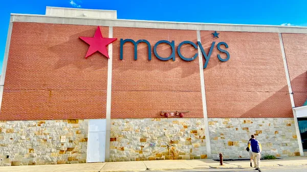 People walking toward a Macy's store.