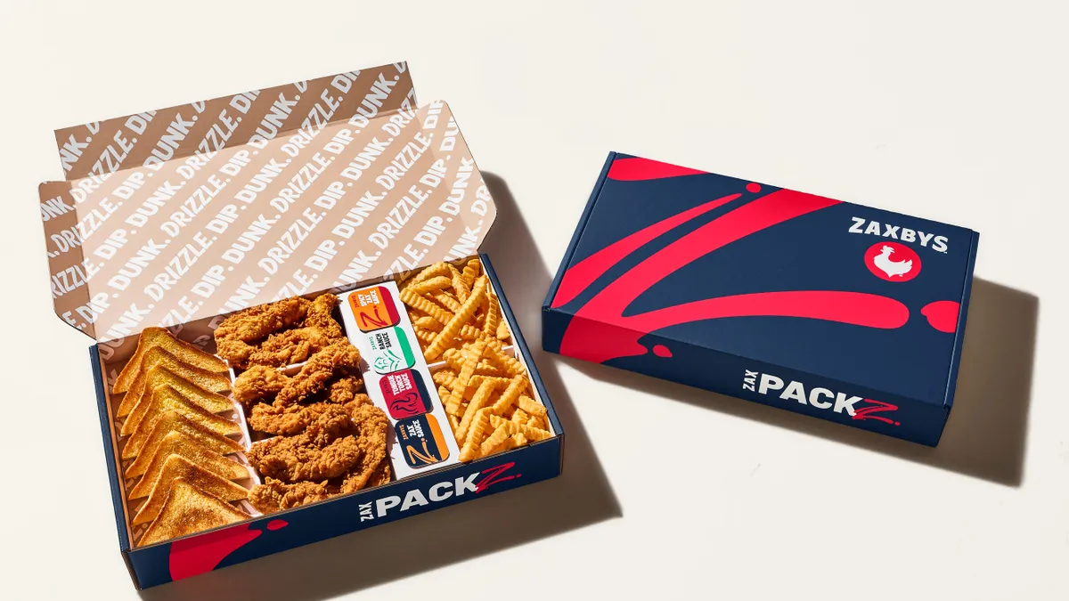 A large Zaxbys chicken finger pack. Many chicken fingers, pieces of toast and fries in a box.