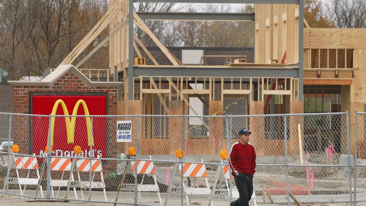 A wood frame of a McDonald's under construction.