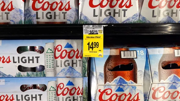 Boxes of Coors Light sit on a shelf.