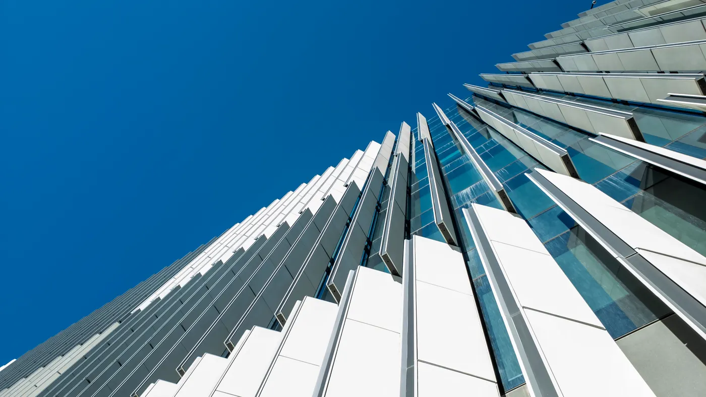 A smart building moves exterior building shades to control heat and energy usage within the interior.