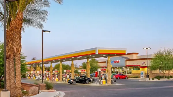 A photo of the exterior of a convenience store and gas station .