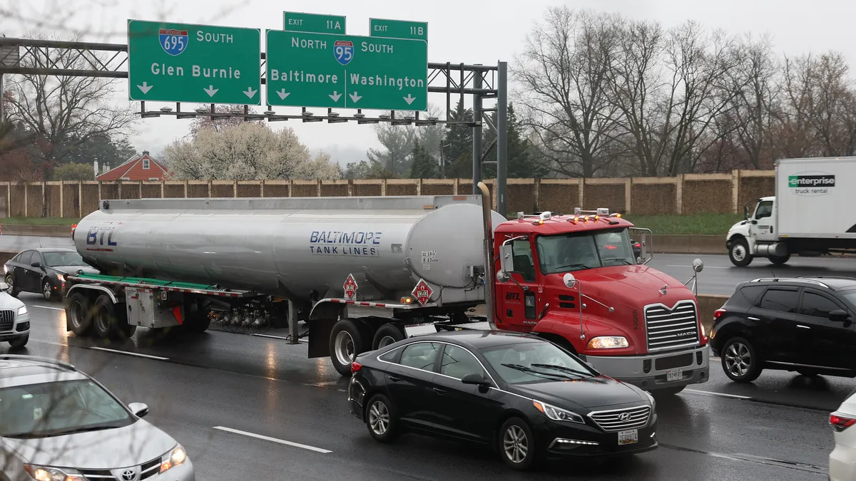 Trucks travel in traffic west bound on I-695 following the collapse of the Francis Scott Key Bridge after the cargo ship Dali crashed into it, March 27, 2024 in Baltimore, Maryland.