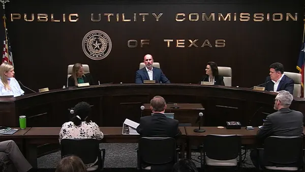 Five commissioners of the Public Utility Commission of Texas sit at a table. They met on June 18, 2026.