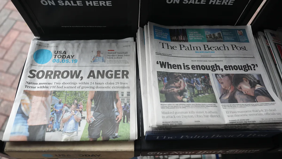 Newspapers stacked for sale.