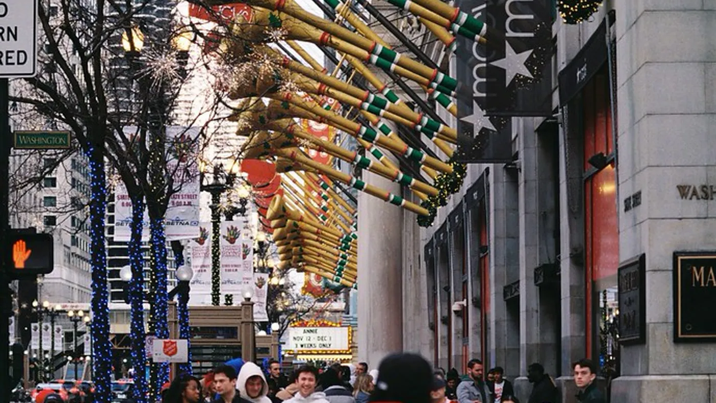 Trumpets decorating the side of a building in a city downtown.