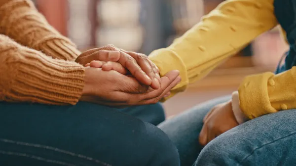 A close up of two hands holding each other