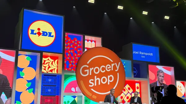 Two people on a conference stage.