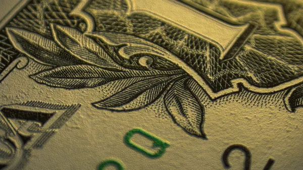 Close-up (macro) image of the upper-right hand corner of a U.S. dollar bill with a little texture added.