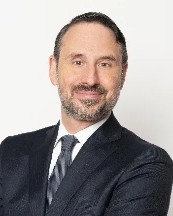 Headshot of a man in a suit.