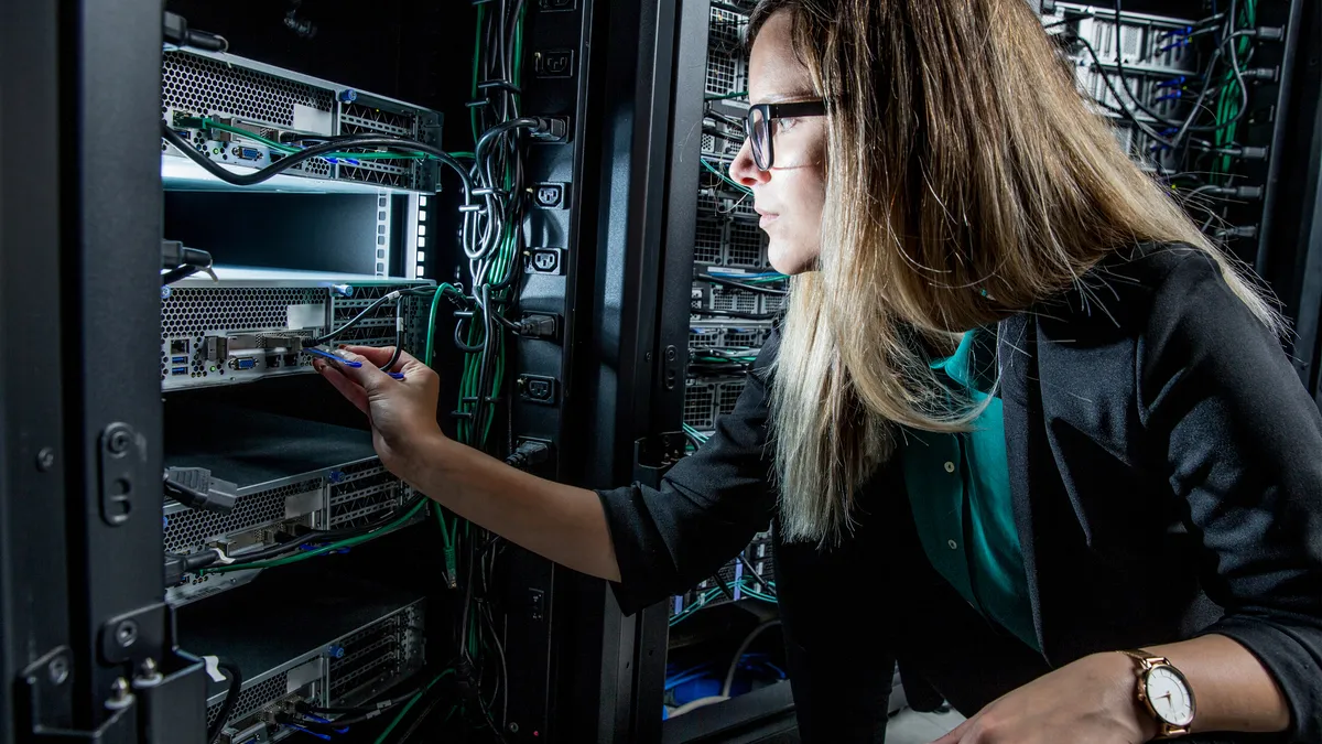 Female IT Engineer Working in Server Room.