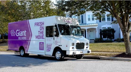 A delivery truck outside a house