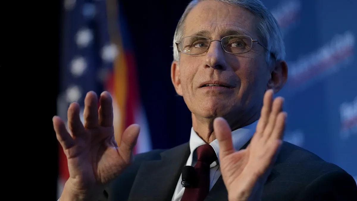 a picture of anthony fauci with both hands raised