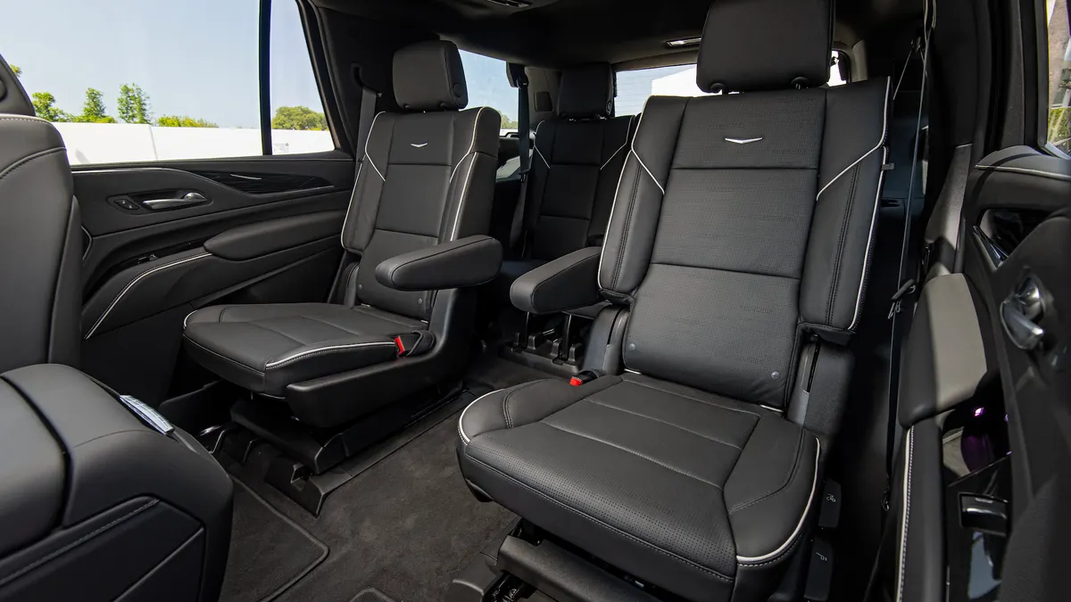 The second-row seats in a 2021 Cadillac Escalade, covered in black leather.