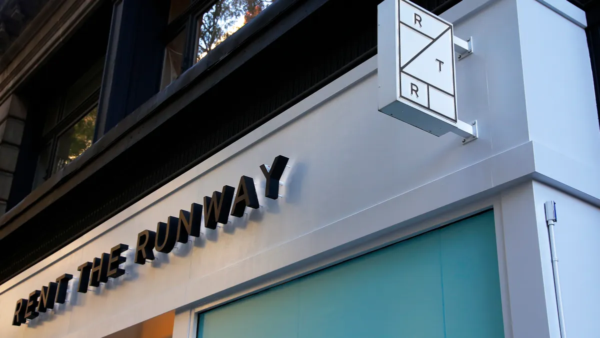 the top corner of a Rent the Runway store is seen from outside on a sunny day.