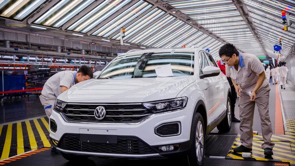 Workers assemble a vehicle at the FAW-Volkswagen factory in Foshan, China.