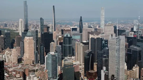A dense urban skyline with multiple tall apartment buildings.
