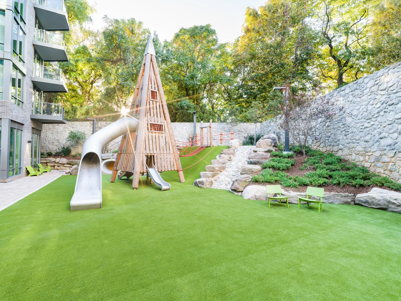 A park on the roof of an apartment building with playground equipment.