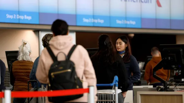 Travelers check in at the airport.