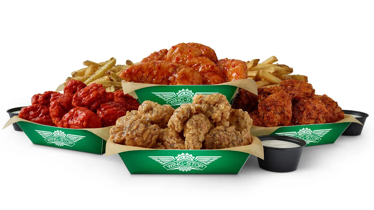 An image of various chicken wings products and French fries inside green containers.