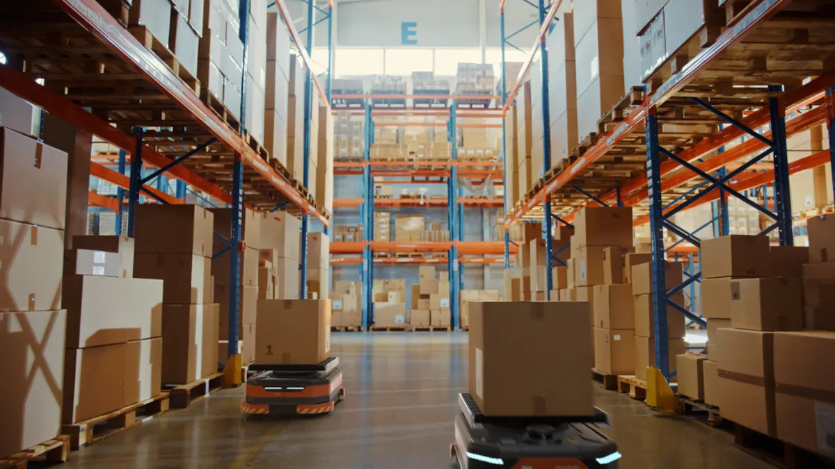 Warehouse with robots carrying boxes