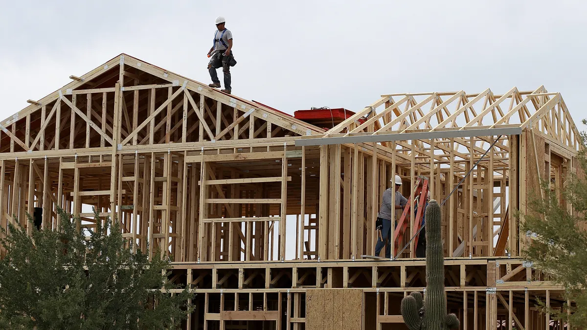 Construction worker on roof of a house in the process of being built