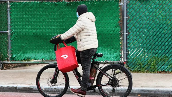 A bike courier with a red delivery bag.