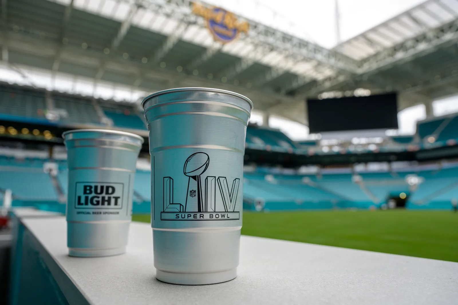 Silver aluminum cups alongside empty stadium field