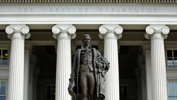 A statue of the first United States Secretary of the Treasury Alexander Hamilton stands in front of the U.S. Treasury.