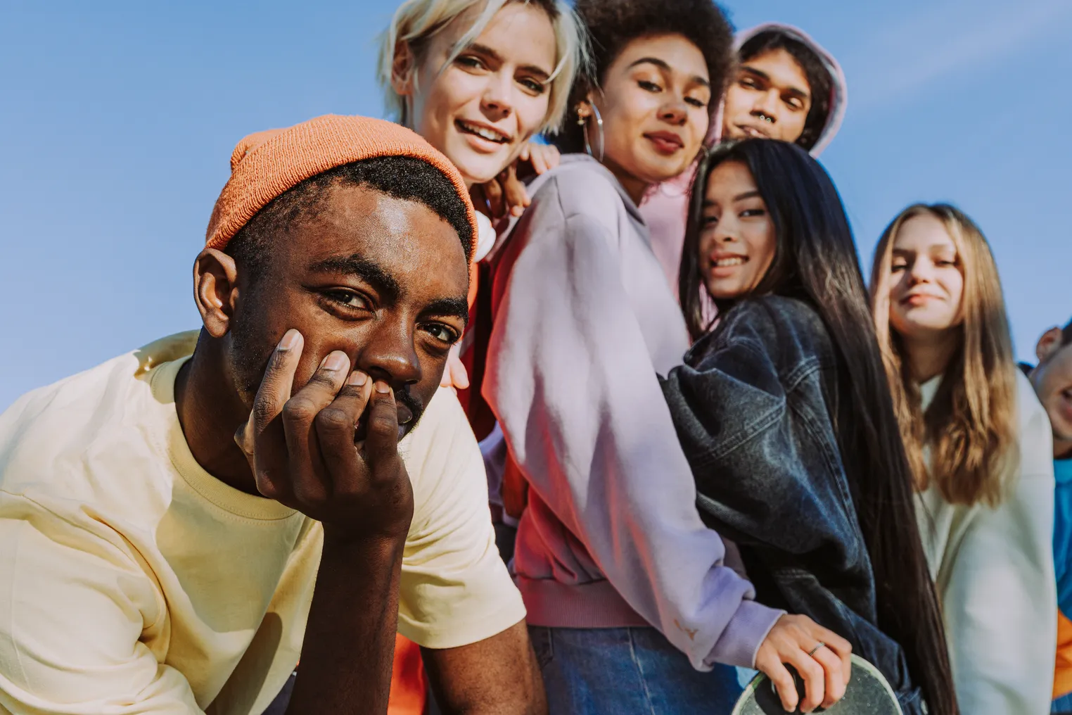 Multicultural group of young friends bonding outdoors