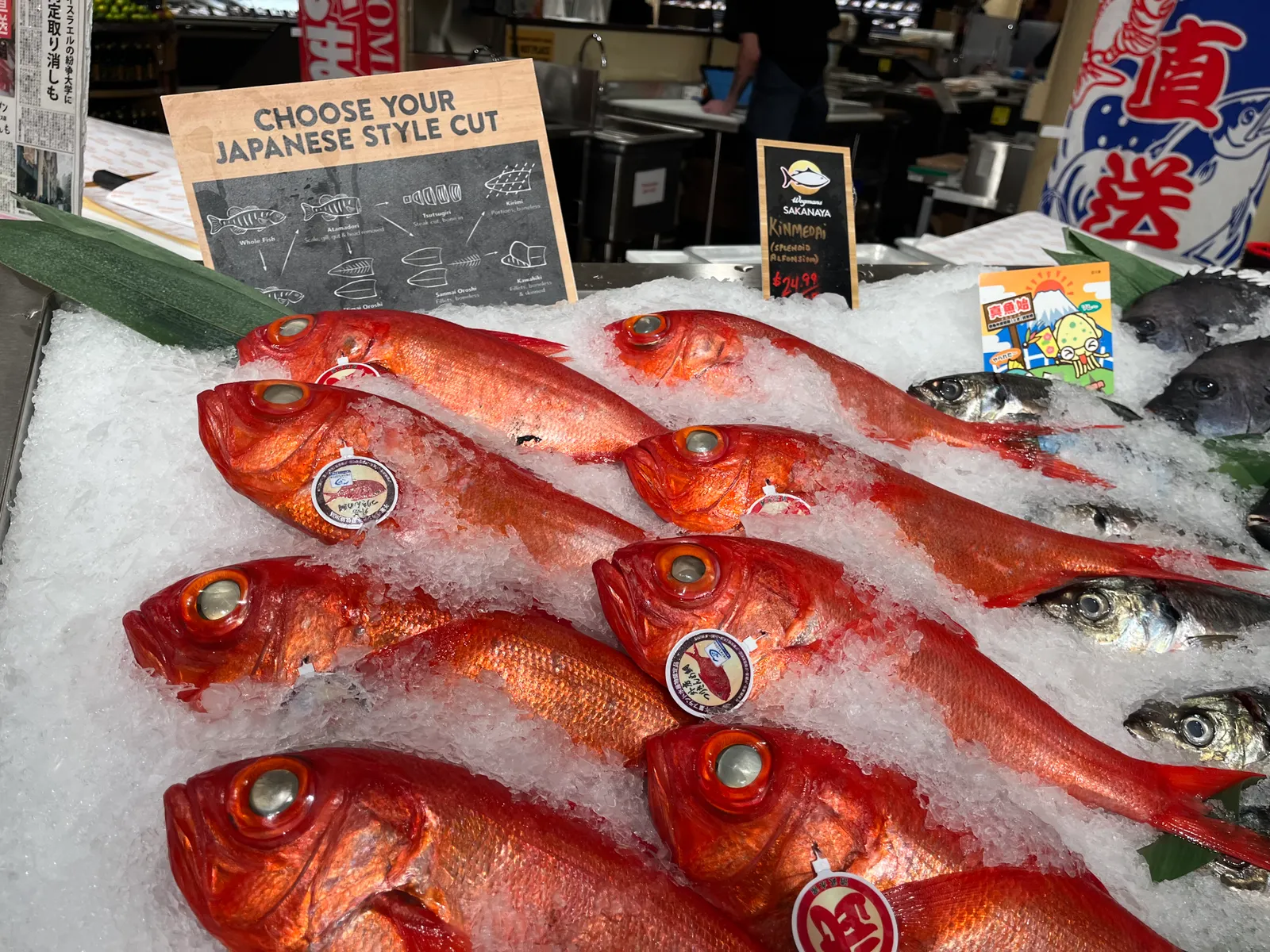 Close-up of fish on ice at a grocery store.