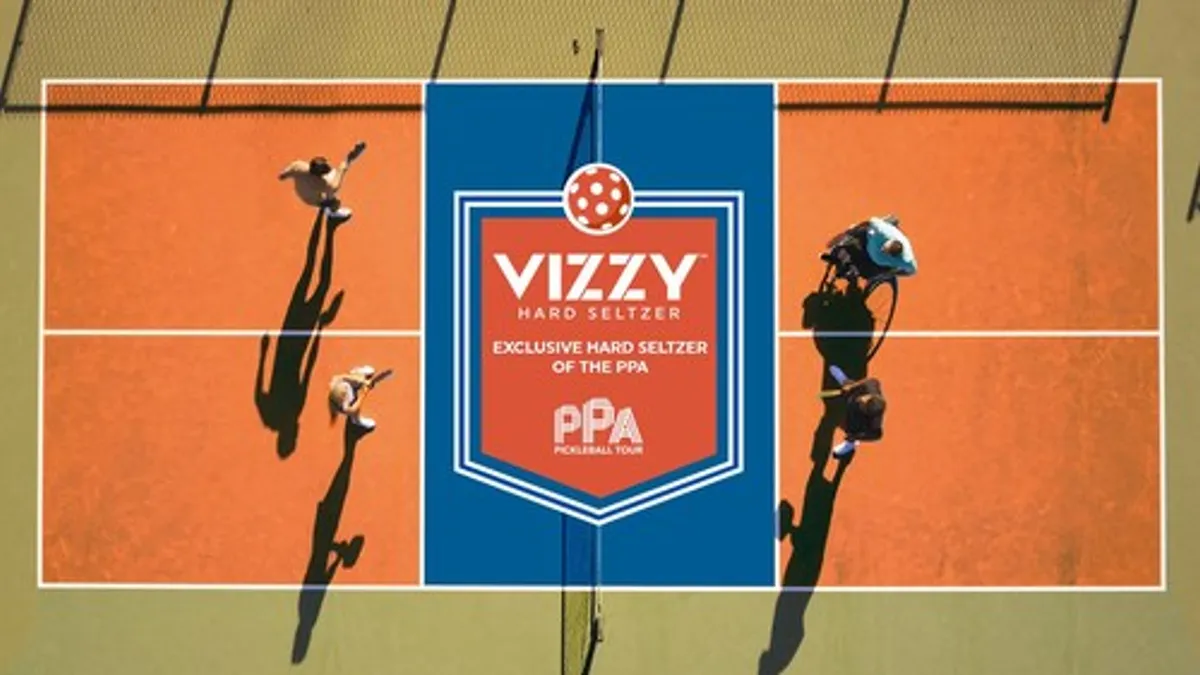 Four people play pickleball on a court with Vizzy's name featured prominently in the middle.