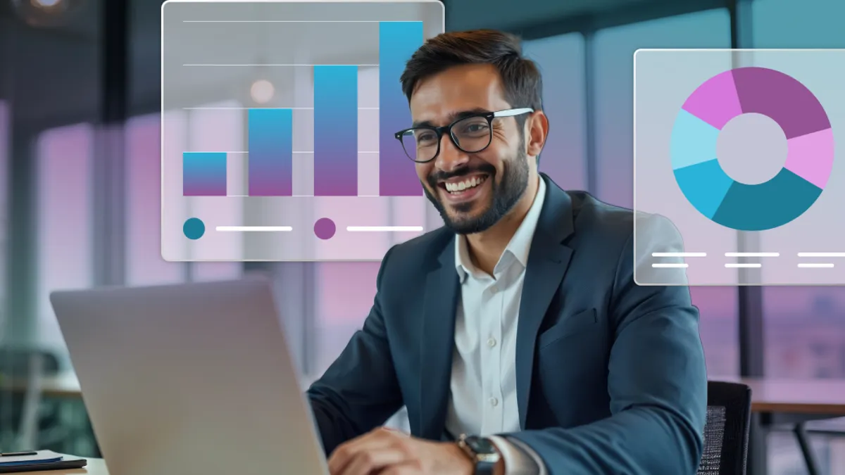 A man wearing a suit in a modern office with a laptop