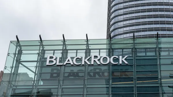 A "BlackRock" logo is displayed on an all-glass facade with a commercial building towering behind it. 