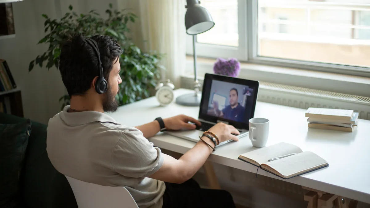 Man interviews for a job on the computer.