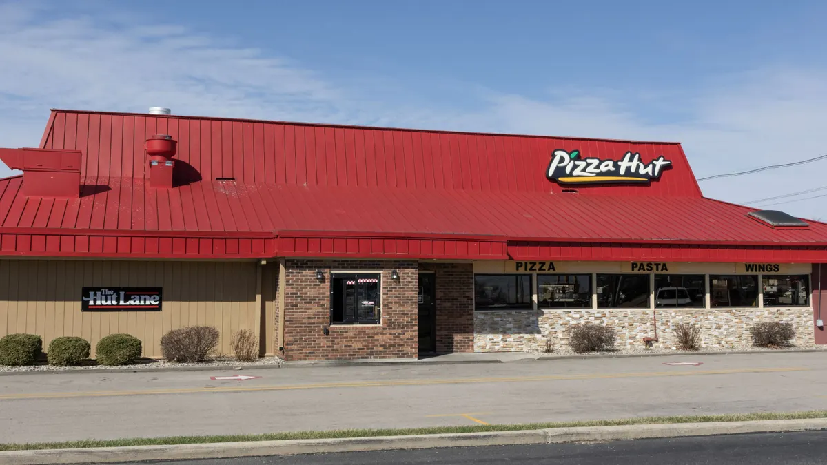 An image of a brick building with Pizza Hut logo on the side.