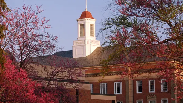 Campanile on a building complex at dusk.