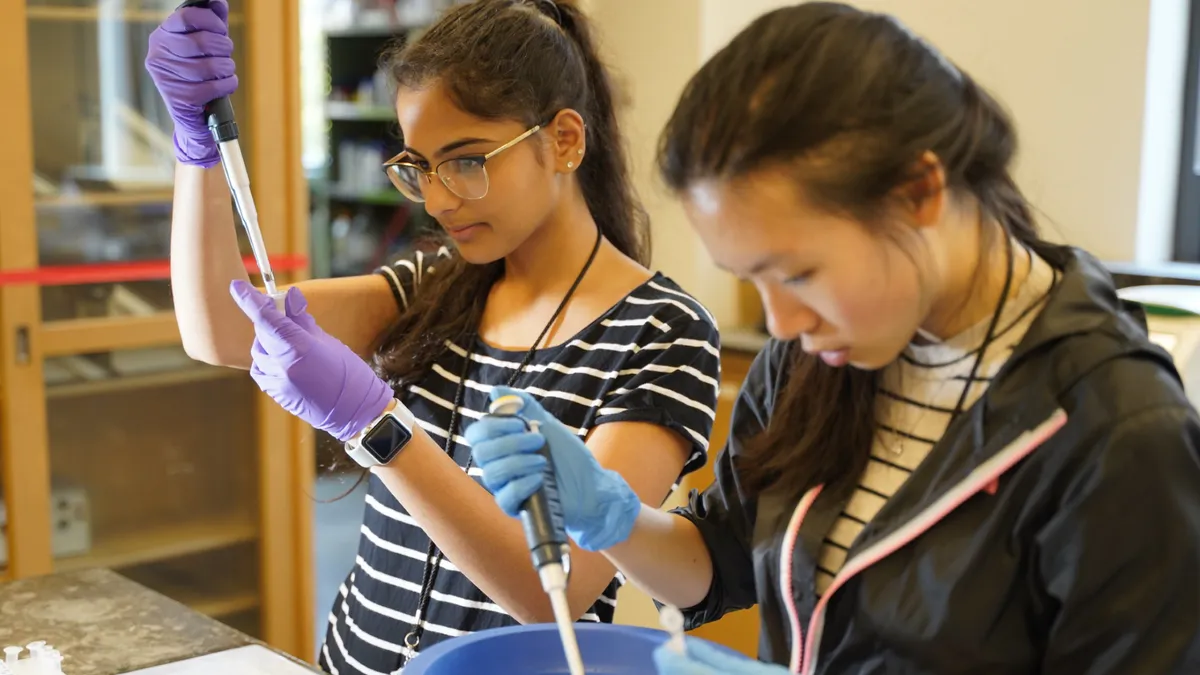 Two students conducting an experiment in the lab.