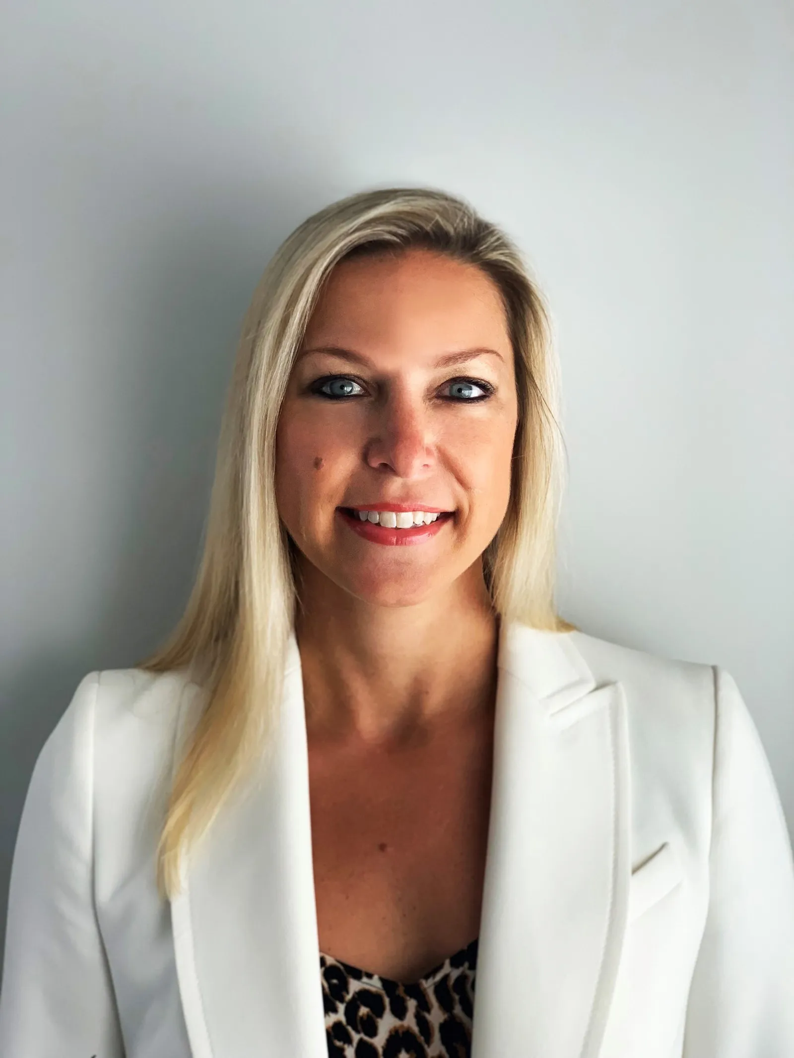 Red Lobster CMO Nichole Robillard wearing a white blazer against a beige background