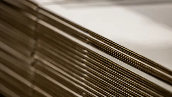 A stack of flattened corrugated boxes.