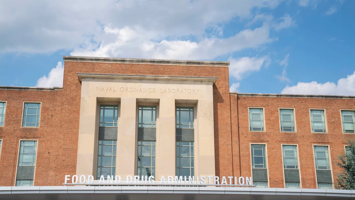 A sign reading Food and Drug Administration is seen above a door to a government building.