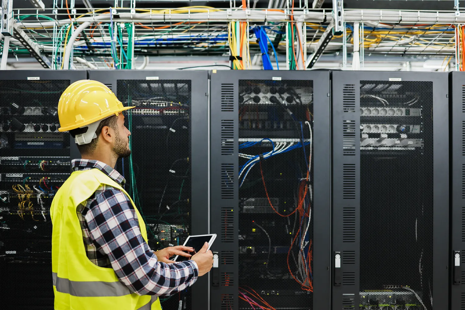 technician man working inside big data center room