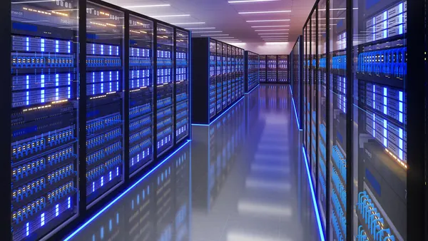Shot of data center with multiple rows of fully operational server racks.
