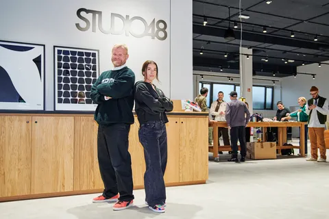 Two employees stand in front of the new creative hub by Puma, Studio48