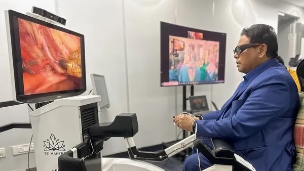SS Innovations CEO Sudhir Srivastava is seated at the surgeon's console of the company's SSi Mantra robotic surgery system.