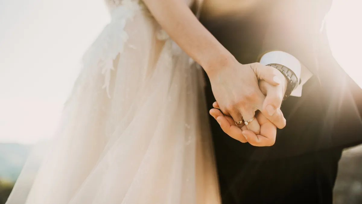 Wedding couple holding hands