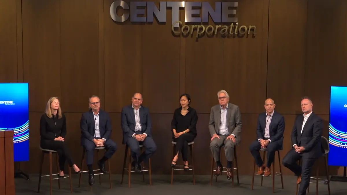 Centene executives sit onstage in a semicircle as they answer questions from analysts.