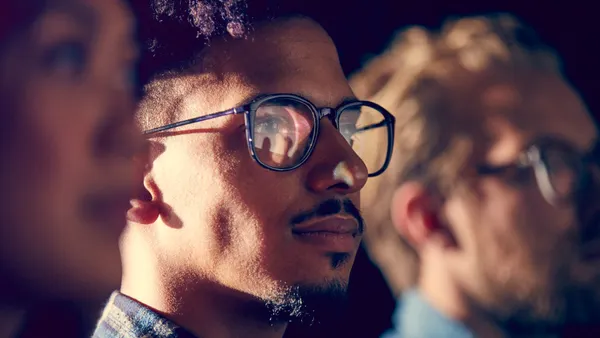 A male employee watches a presentation